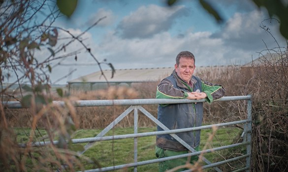 Farmer on a gate at Newlands Farm.